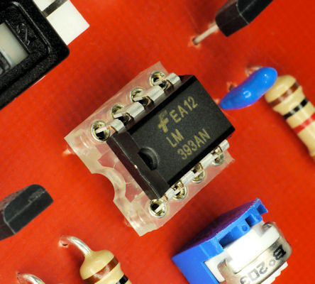 Chip-in-clear-socket-on-red-printed-circuit-board.jpg