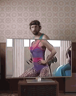 dude-drinking-beer-behind-tv-exercise-routine.gif