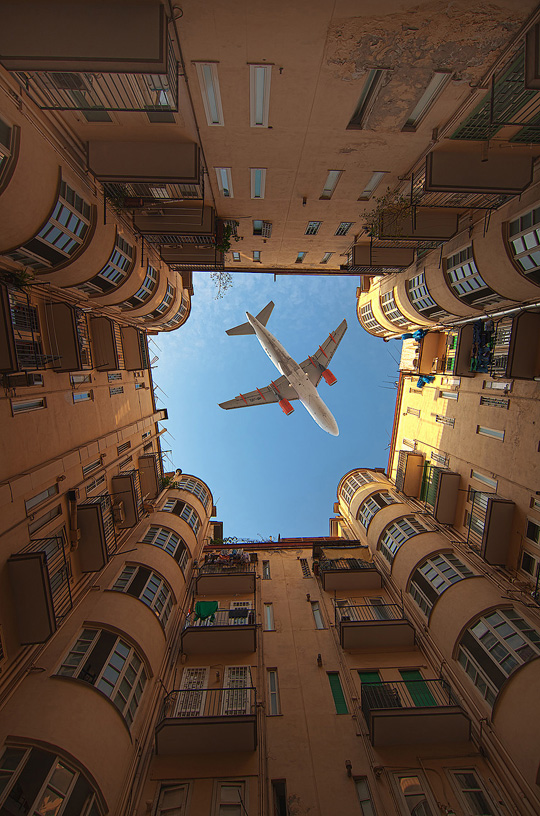 plane_flying_over_buildings.jpg
