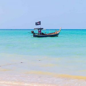 White sand beach and pirate boat